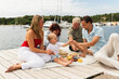 © Diego Martin/Stocksy - Family with Children and Grandparents Enjoying Picnic on Jetty
