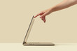 © Yaroslav Danylchenko/Stocksy - Silver laptop getting activated by owner while standing in studio
