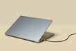 © Yaroslav Danylchenko/Stocksy - USB flash drive connected to grey laptop in studio