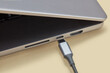 © Yaroslav Danylchenko/Stocksy - Micro usb wire attaching to connector in laptop with aluminum case