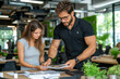 © zakiroff - Collaborative workplace discussion, young professionals engaged in teamwork, casual office environment, teamwork concept