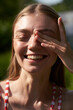 © Elena Kharichkina/Stocksy - Young Woman Posing Outdoors With Hand Over Eye