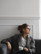 © ollyta may - Sitting young woman with mug of coffee or tea woman surrounded by a minimalist interior. Modern phohgraphy with concept of woman's business or working from home
