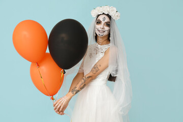 Poster - Beautiful young woman dressed as dead bride for Halloween party with balloons on blue background