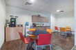 © alhim - A room in a modern office for relaxing and snacking. A small kitchen set, a cooler and .a coffee machine. Round tables and colorful chairs.