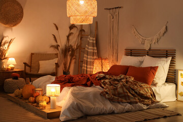 Sticker - Interior of stylish bedroom with autumn decorations and candles in evening