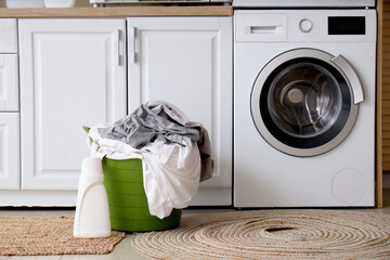 Wall Mural - Interior of home laundry room with washing machines, counter and basket with clothes