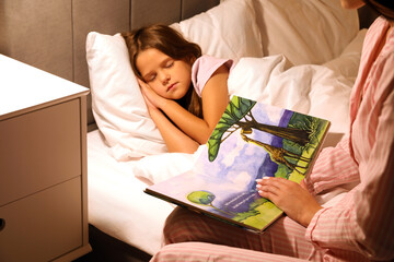 Poster - Mother reading fairy-tale for her sleeping little daughter in bed at night