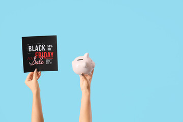 Poster - Female hands with piggy bank and text BLACK FRIDAY SALE on blue background