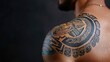 © CHA - Showcase of a detailed tribal tattoo on a male shoulder, representing culture and artistry. The vibrant ink combines traditional elements with modern design.