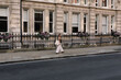 © Adrian Rodd/Stocksy - A young tourist strolling through the streets of london