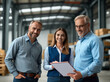 © Tatiana Sidorova - Portrait of a business team in industrial warehouse settings discussing project consulting details on the clipboard