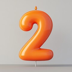 A glossy orange number 2 candle on a simple background.