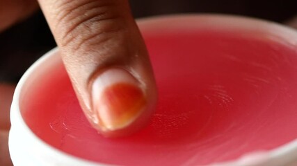 Wall Mural - woman using petroleum jelly onto skin at home close up.