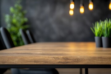 Stylish modern office table with plant decor and warm pendant lighting.