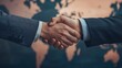 © Jakrapan - Global Partnership: A powerful handshake seals a significant deal, symbolizing international collaboration and mutual success against a world map backdrop.
