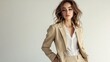 © The Little Hut - Elegant style A beautiful fashion model poses in a loose beige pantsuit on a white background Female fashion Fulllength studio portrait : Generative AI