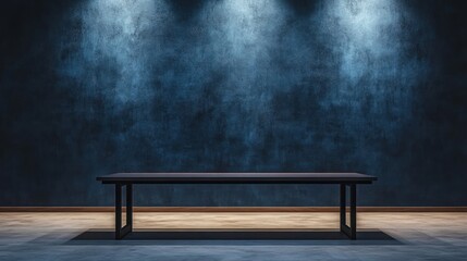 Canvas Print - A minimalist room with a dark wall and a simple table, illuminated by overhead lights.