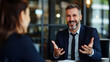 © Favio - Smiling businessman in suit during a meeting with a female colleague at office.