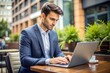 © Introvertia - Caucasian businessman typing on laptop in cafe professional and business casual