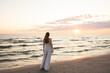 © Hernandez & Sorokina/Stocksy - Anonymous woman enjoying sunset view in the beach