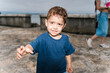 © Ezequiel Giménez/Stocksy - Curious Child by the Harbor