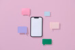 © Marc Tran/Stocksy - Smartphone With Colorful Speech Bubbles On Pink Background