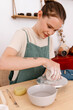 © Tania Cervian/Stocksy - Woman using pottery wheel to create ceramic artwork