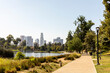 © Jayme Burrows/Stocksy - Walking Path at Echo Park Lake with Downtown LA Skyline in the B