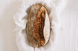 © Adrian Cotiga/Stocksy - Loaf of homemade seed bread wrapped in white cloth