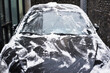 © SIYUN YUH/Stocksy - Black car scrubbed of snow in winter