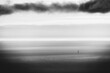© VICTOR TORRES/Stocksy - Minimalist black and white seascape with a distant lone sailboat