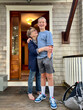© Raymond Forbes LLC/Stocksy - Grandmother and family portrait Grandson waiting for school bus UGC