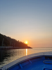 Wall Mural - 
It is a sea where the sunset is visible from the bow of the ship.