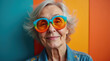 © StockShop - Colorful Portrait of Elderly Individual with Vibrant Glasses – Surreal and Joyful Senior Photography for Fun, Age Diversity, and Creativity