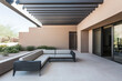 © JuanM - Modern outdoor lounge area with sectional sofa in a desert residence on a sunny day