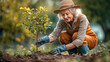 © Elvira - An elderly woman planting a tree