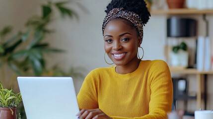 Canvas Print - Young woman with laptop smiling in bright workspace