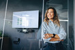 © Jacob Lund - Successful business woman smiling confidently in an office