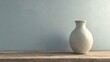 © MakoPoko - Simple vase resting on a rustic wooden table against a plain gray wall minimalist interior decor concept