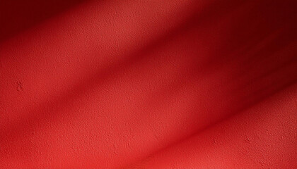 Empty red textured wall close up with shadows. Sparse texture and background