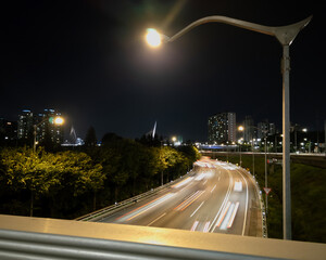 road view of long exposure traffic at night, capturing the vibrant energy and motion of the scene