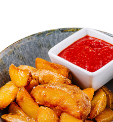 Delicious fried potato wedges with tomato sauce and spices