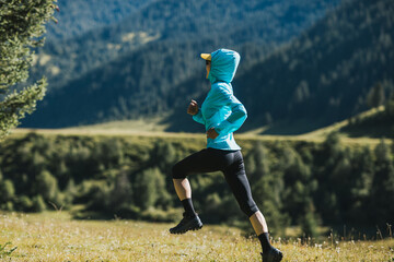 Poster - Fitness asian woman runner running at sunrise grassland