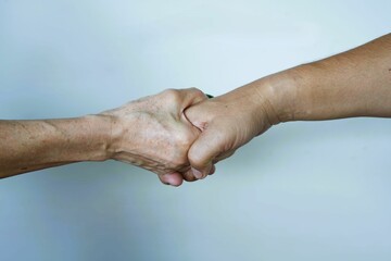 Two hands holding a handshake, symbolizing a successful partnership between two people