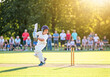 © EvgeniiaFreeman - Young boy playing cricket in summer sunshine: dynamic action shot capturing energy and fun