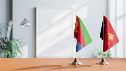 FLAGS OF ERITREA AND PAPUA NEW GUINEA ON TABLE