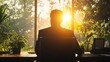 © Prapan - silhouette of an executive sitting at a sleek modern desk,