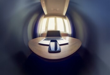Aufkleber - A fisheye lens view of a wooden table with a laptop and a cell phone near a window with white blinds.