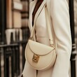 © Aleks - Elegant Beige Handbag Fashion Accessory with Stylish Blazer on Model in Urban Setting.